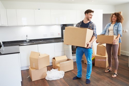 Professional movers carrying furniture during a local Chasecross relocation