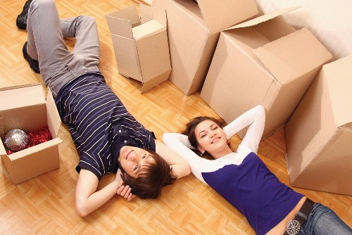 Local movers handling furniture in a Chasecross home